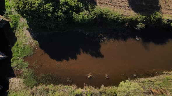 A drone pans over an ancient Roman bridge in a top-down view. alt