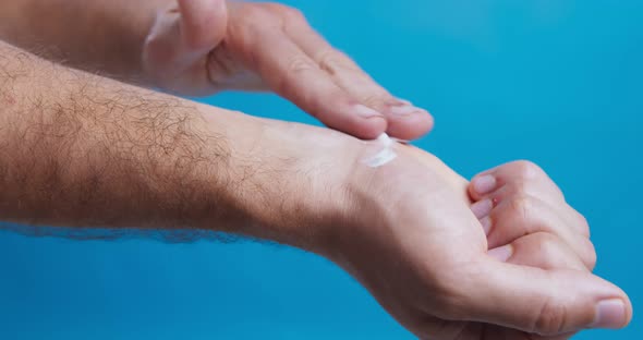 Man Applying Healing Cream on Wrist, Treating Occupational Disease alt