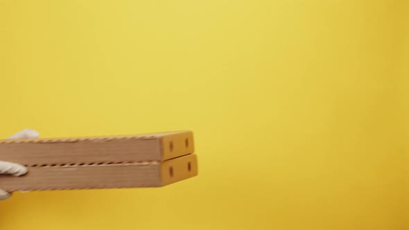 Square Cardboard Boxes on Yellow Background alt