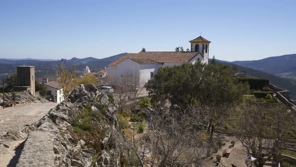 Espirito Santo church in Marvao on the middle of a beautiful landscape and city walls alt