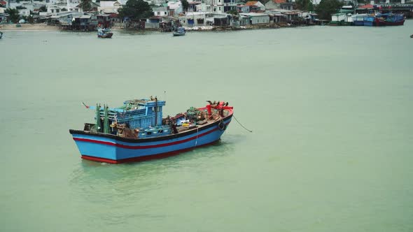 Fishing Boat At Anchor Off Poor Village In Nha Trang alt