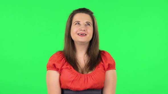 Portrait of Cute Girl Is Daydreaming and Smiling Looking Up. Green Screen alt