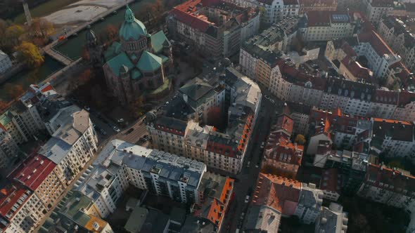 Tilt Down Aerial Shot Above Typical Germany City Neighbourhood in Munich Next To Beautiful Cathedral alt