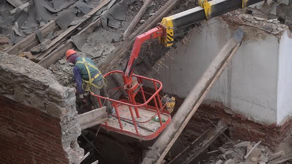 Demolition of Old Abandoned House Workman in Orange Helmet at Crane Basket Destroy Wooden Roof with alt
