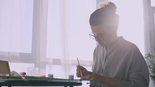 Lady Artist with Glasses Drawing at Home