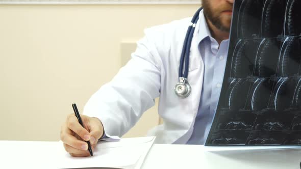 The Doctor Is Analyzing the Patients X-Ray alt