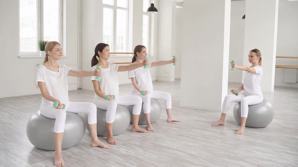Group of Pregnant Women Sitting on Fitness Ball Going in for Sports