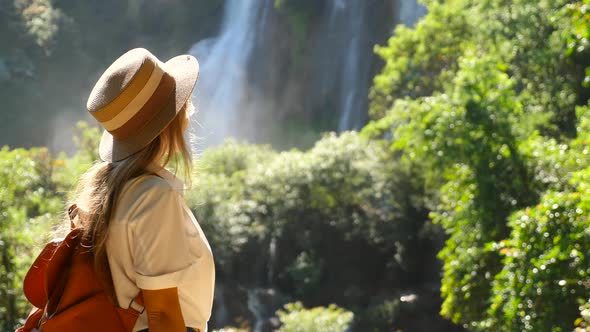 Travel Woman Enjoy Amazing View of Waterfall Nature alt