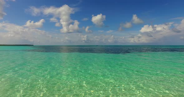 Wide angle aerial tourism shot of a white paradise beach and turquoise sea background in hi res 4K alt