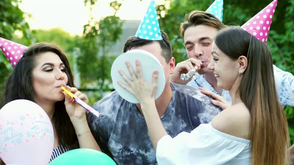 Friends Throw Birthday Cake at Mans Face, He Smiles and Laughs, Joke on Party alt