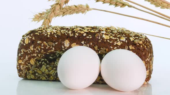 Close Up Rotation Bread Still Life On A White Background, Spikelets Of Wheat With Bread alt