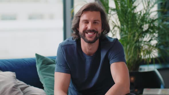 Portrait of confused man in living room alt