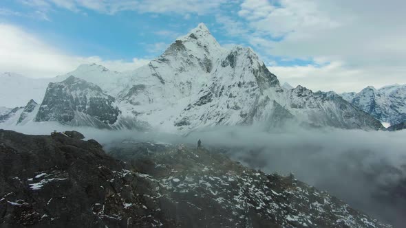 Man Looking on Ama Dablam Mountain. Himalaya, Nepal. Aerial View alt