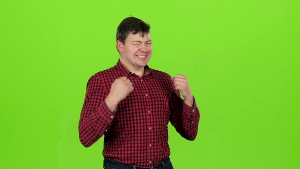 Young Guy Is Happy with His Victories, He Is Happy. Green Screen. Slow Motion alt