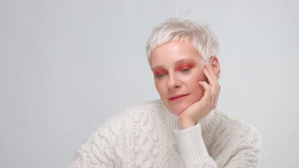 Blonde Woman with Short Haircut Wears Knitted Sweater