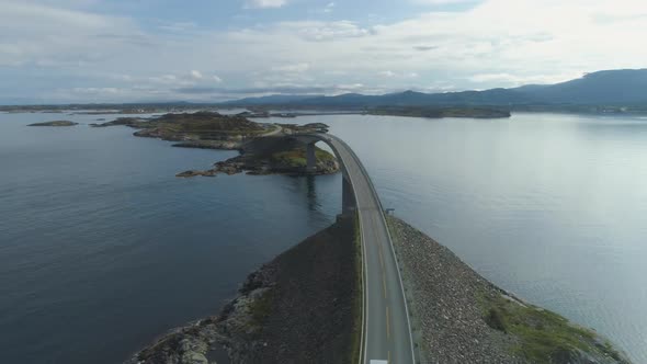 Car with Motorhome Travels on Storseisundet Bridge. Atlantic Ocean Road in Norway. Aerial View alt