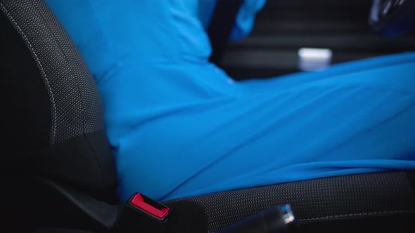 Woman Fastening Car Safety Seat Belt While Sitting Inside of Vehicle Before Driving alt