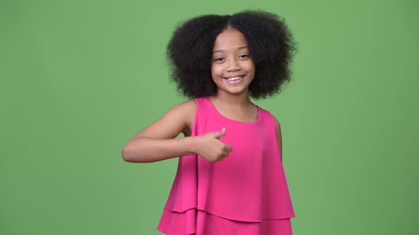 Young Cute African Girl with Afro Hair Giving Thumbs Up alt
