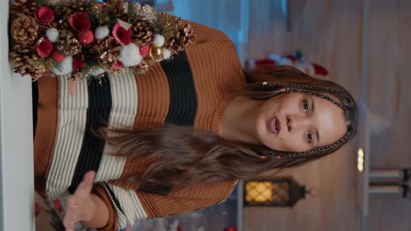 Vertical Video Young Adult Waving at Video Call Camera in Festive Kitchen alt