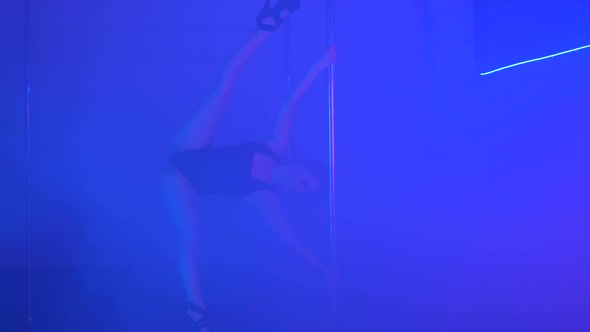 Young Sexy Slim Woman Pole Dancing with Pylon in Dark Interior alt