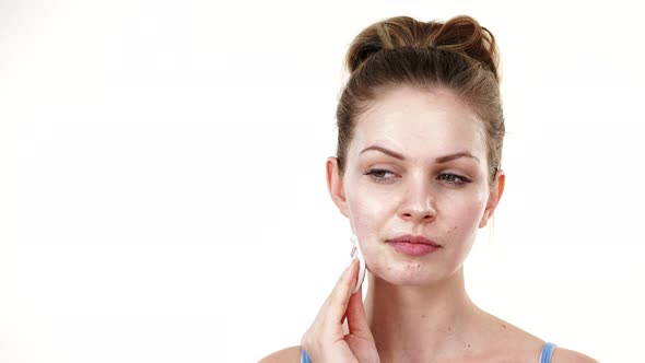 Woman Removing Mask Cream from Face