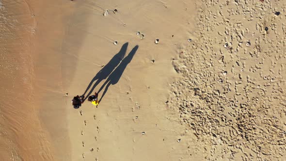 Modern happy ladies travelling enjoying life at the beach on summer white sandy and blue background  alt
