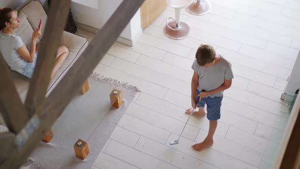 Boy at Home During Quarantine Due Ncov19 Coronavirus Outbreak Life Stile in Apartment Playing Golf alt