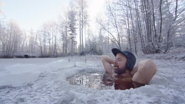 The ice bather puts his arms behind his head and relaxes into the session alt