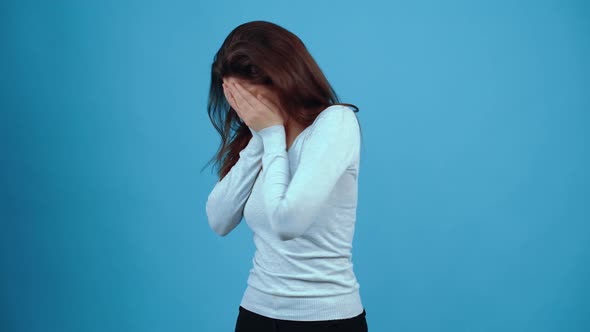 The Young Brunette Sad Cries Desperately with Her Face in Her Hands Finally Asking for Help with Her alt