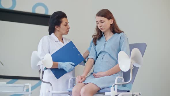 Teenager Pregnant Feeling Sad Empathy While Visit Gynecologist Doctor at the Medical Clinic. alt