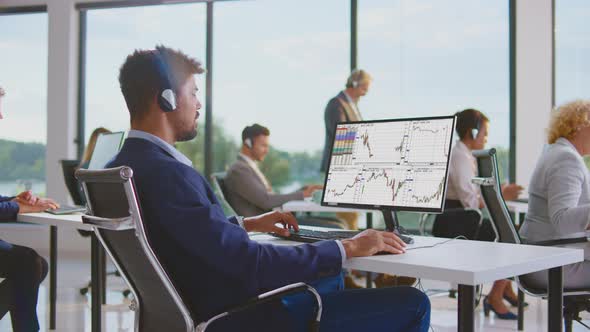 Man looking at charts on monitor