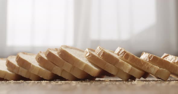 Sliced White Bread Falling On The Table In Slow Motion alt