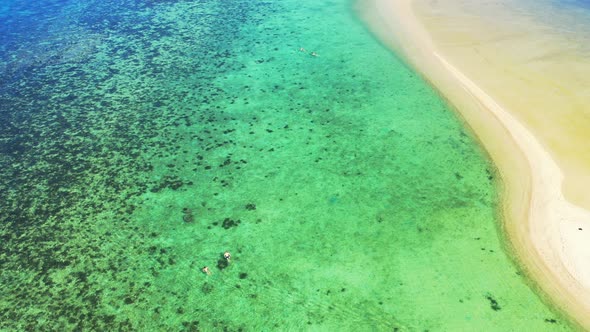 Wide overhead abstract shot of a sunshine white sandy paradise beach and aqua blue water background  alt