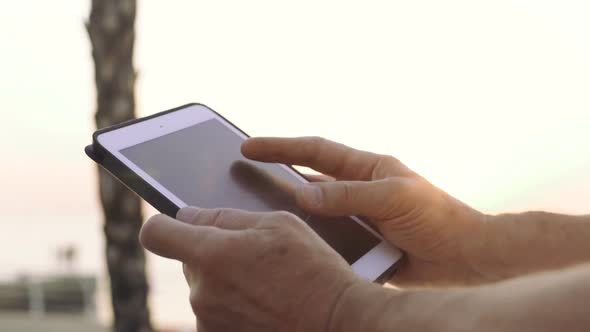 Portrait of Retirement Handsome Senior Man Using Tablet Computer on Seafront Close Up alt