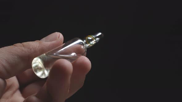 Man's Hand Holds an Ampoule for Injection on a Dark Background. Coronavirus, Pandemic alt