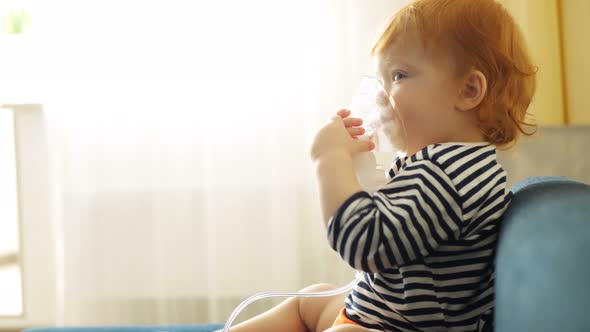 Sick Redhead Baby Girl Breathes in a Nebulizer