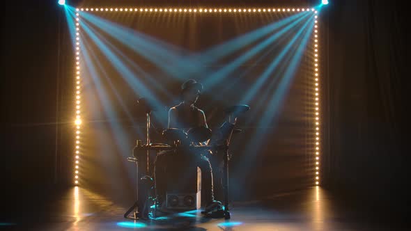 A Solo Performance By a Musician Drummer in a Dark Studio in the Rays of Blue Light. A Silhouette of alt