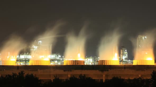 Time-lapse of Cooling tower of oil refinery industrial plant at night, Thailand