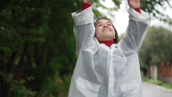 Medium Shot Portrait of Happy Little Woman Looking Up Stretching Hands in Slow Motion Smiling alt