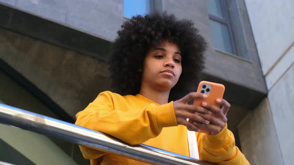 Beautiful Woman Using Phone Walking On Street. Portrait Of Stylish Smiling Business alt