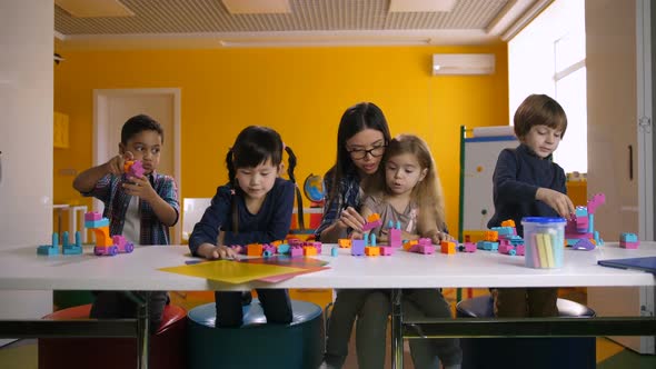 Kids Playing with Construction Blocks in Classroom alt