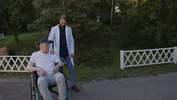 Doctor Support His Old Man in Wheelchair alt