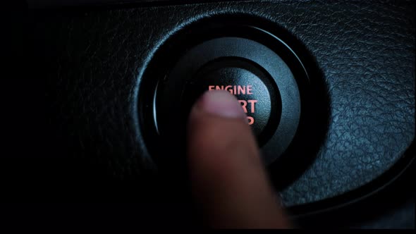 Hand press the button to start stop the car engine, Starting car engine. Close up