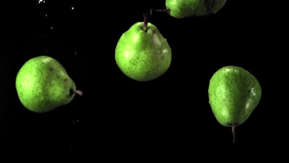 Super Slow Motion Green Pears Fall on the Water with Splashes alt