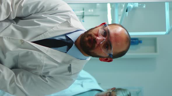 Vertical Video Portrait of Exhausted Chemist Looking at Camera alt
