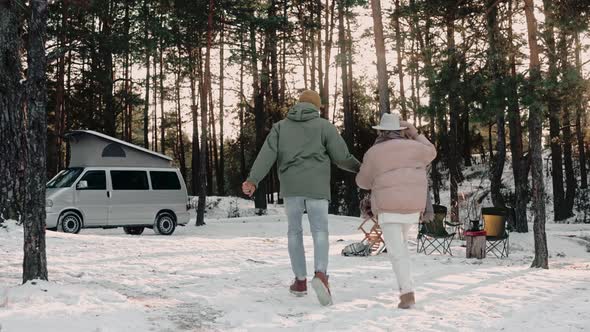 Romantic Couple Happily Walk Through Wood Camp Holding Hands Enjoying Van Life