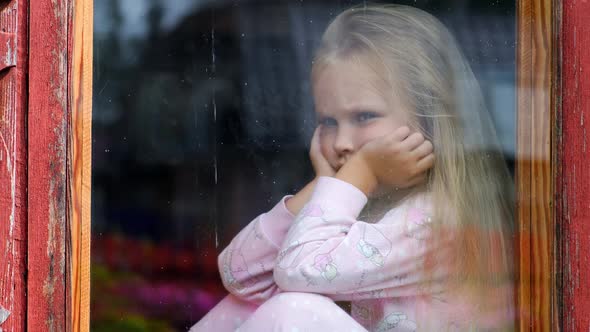 Child in an old house by the window