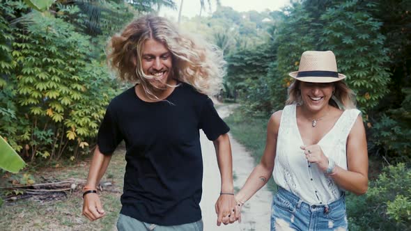 Couple Running At The Jungle