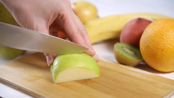 Woman Food Blogger Cuts Green Apple for Fruit Salad