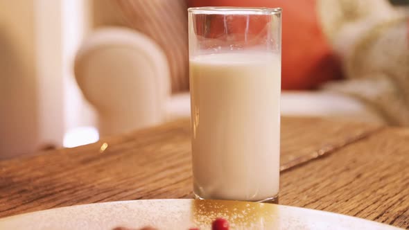 Christmas cookies on plate with a glass of milk alt